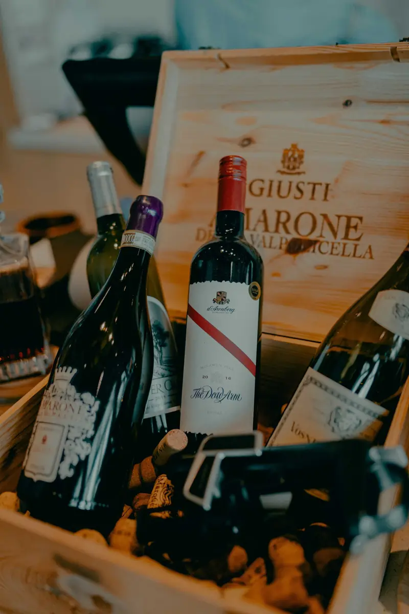 Wine bottles resting in a wooden crate